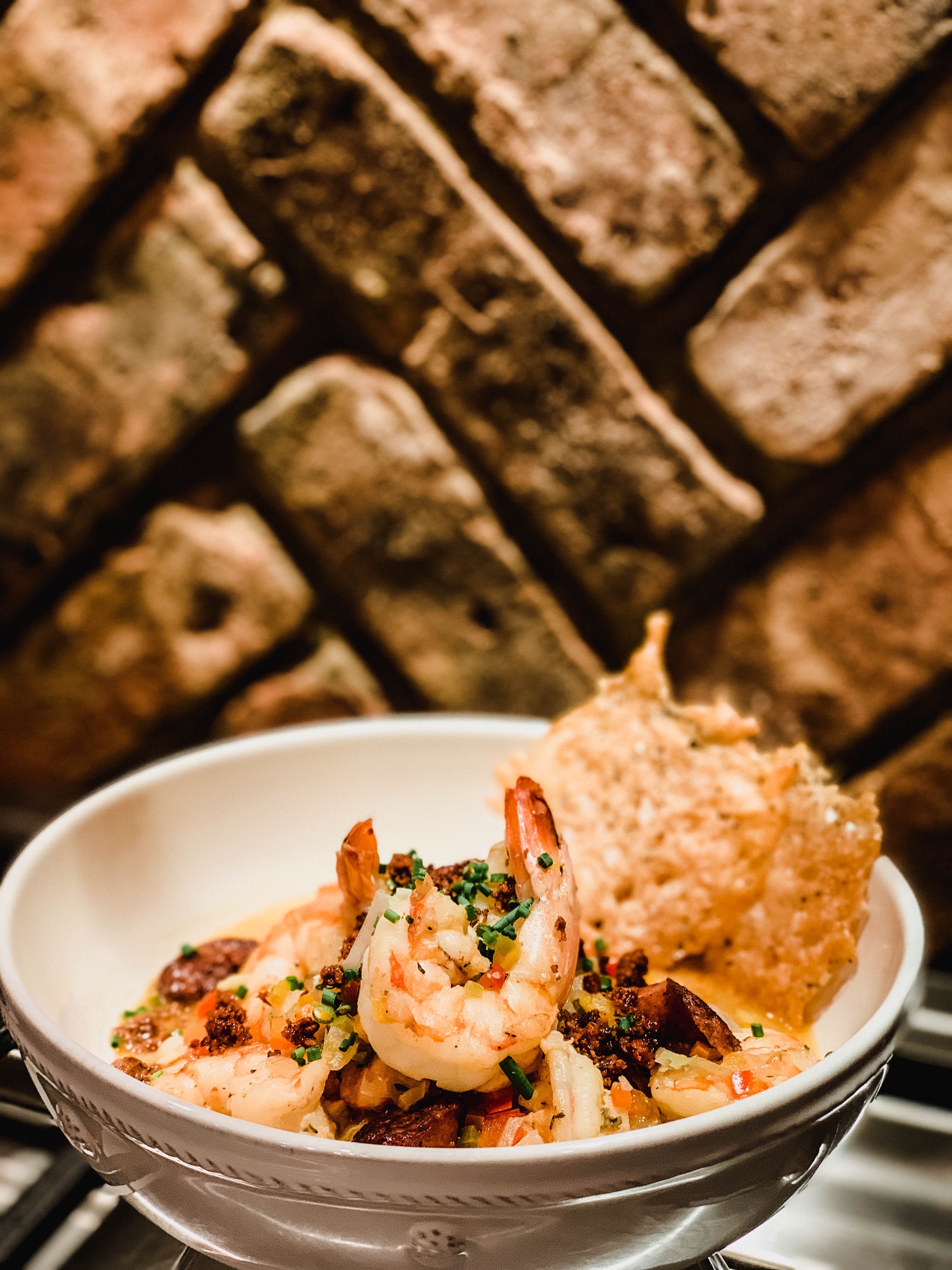 SHRIMP AND GRITS WITH CHORIZO AND PARMESAN CRISPS