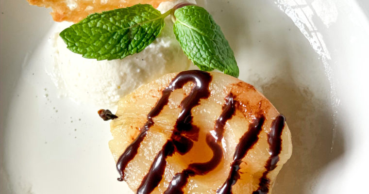 Poached pears with chocolate sauce and coconut crisp